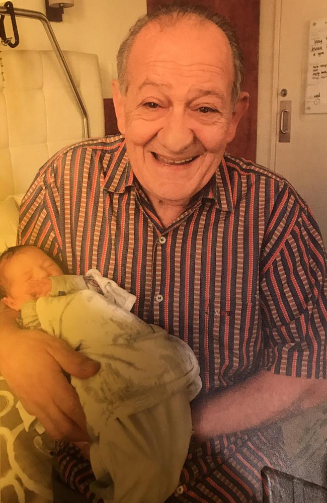 Sisto holds his first grandchild, Sophia, who was born just a week before his death.