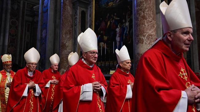 The Vatican's Secretary of State Cardibal Pietro Parolin, centre, and Cardinal Robert Francis Prevost, second right, attend mass at St Peter's Basilica. Picture: AP