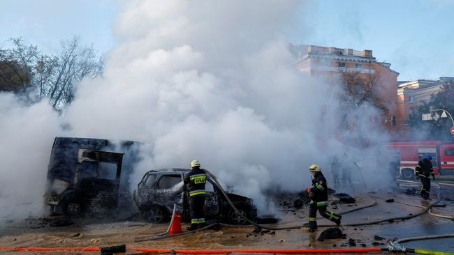 Firefighters work to put out a fire at the scene of a Russian missile strike in Kyiv overnight (AEDT). Picture: Reuters