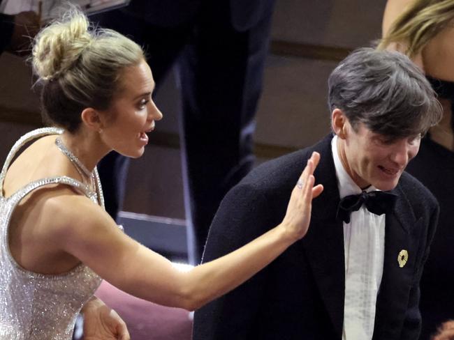 Emily Blunt and Cillian Murphy as he makes his way to the stage. Picture: Getty Images