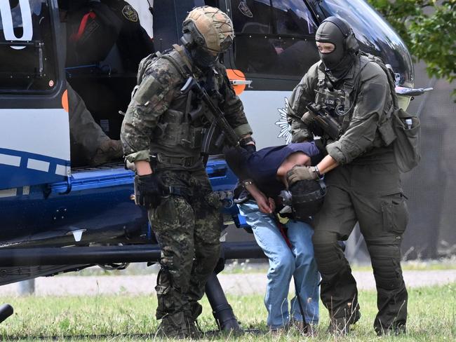 Members of a special police unit escort a man suspected to be responsible for the Solingen knife attack from a helicopter to the office of the Federal Prosecutor in Karlsruhe, southern Germany. Picture: AFP