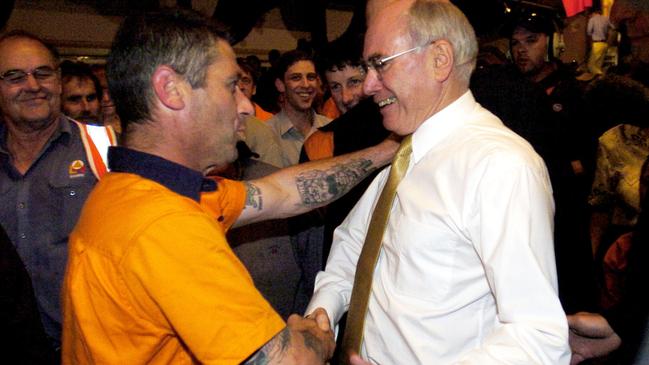 John Howard greets a forestry worker after addressing a rally of 3,000 timber workers in Launceston in 2004. Picture: AAP.