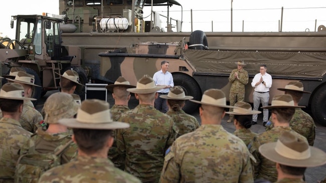 Richard Marles, centre, talking to army personnel that went to help in Vanuatu