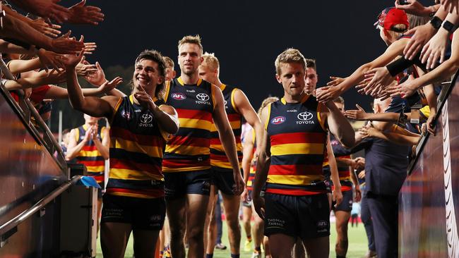 Joshua Rachele and a clearly flat Rory Sloane lead the players down the race. Picture: AFL Photos via Getty Images