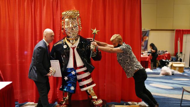 Matt Braynard (L) helps artist Tommy Zegan (R) move his statue of former President Donald Trump to a van during the Conservative Political Action Conference. Picture: Getty