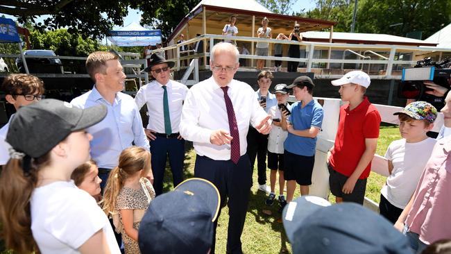 Prime Minister Scott Morrison talks to a group of children at the Brookfield Showgrounds in Brisbane's west on Wednesday. Picture: NCA NewsWire / Dan Peled