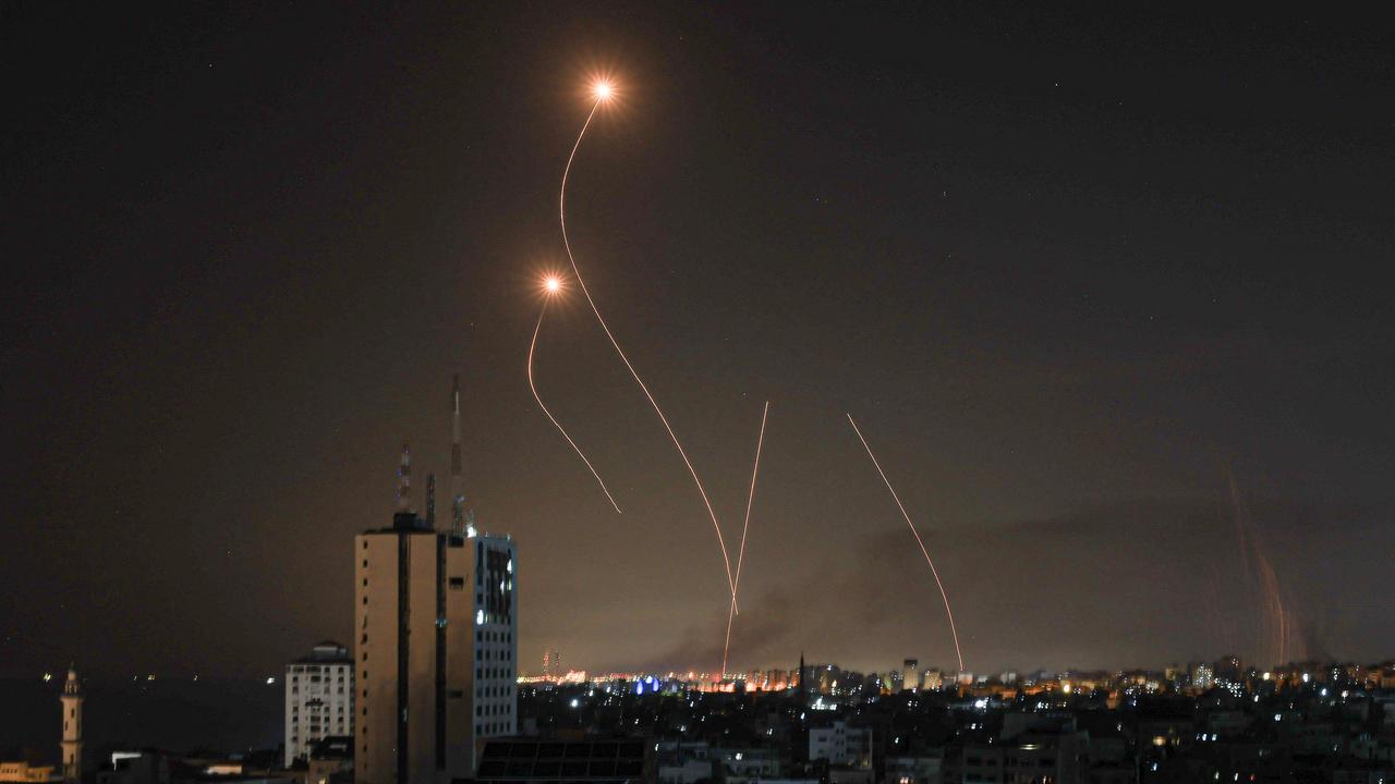 An Israeli missile launched from the Iron Dome defence missile system attempts to intercept a rocket, fired from the Gaza Strip, over the city of Netivot in southern Israel on October 8, 2023. Picture: Mahmud Hams / AFP)