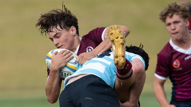 Queensland’s Sean Weir takes a massive hit. Picture: Julian Andrews