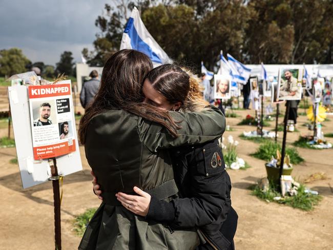 TOPSHOT - Two women react while visiting the site of the Supernova music festival near Kibbutz Reim, southern Israel, on February 19, 2024. Thousands of visitors in Israel have been flocking weekly to the site of the Supernova music festival, to pay their respects to the 364 people killed there by Hamas in the October 7 attacks. The Supernova festival saw the highest toll by far of the sites attacked when Hamas militants broke through from Gaza into southern Israel in an unprecedented attack, which resulted in the deaths of more than 1,160 people. In response, Israel launched a military campaign that has killed at almost 30,000 people in Gaza, mostly women and children, according to the Palestinian territory's health ministry. (Photo by RONALDO SCHEMIDT / AFP) / To go with 'Israel-Palestinians-conflict' by Michael BLUM #MER62