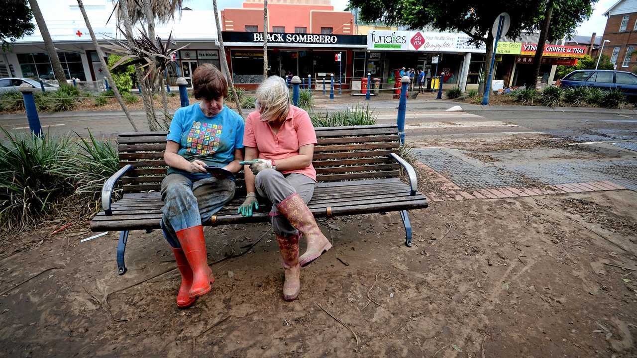 Wendy Wilson and Leanne Beattistuzzi, of Lismore, take a break from cleaning up. Picture: Marc Stapelberg