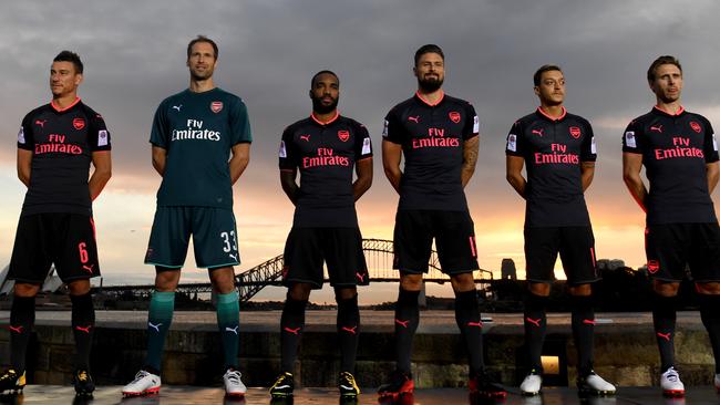 Alexandre Lacazette and his new Arsenal FC team-mates model the team's new third kit on Fort Denison in Sydney.