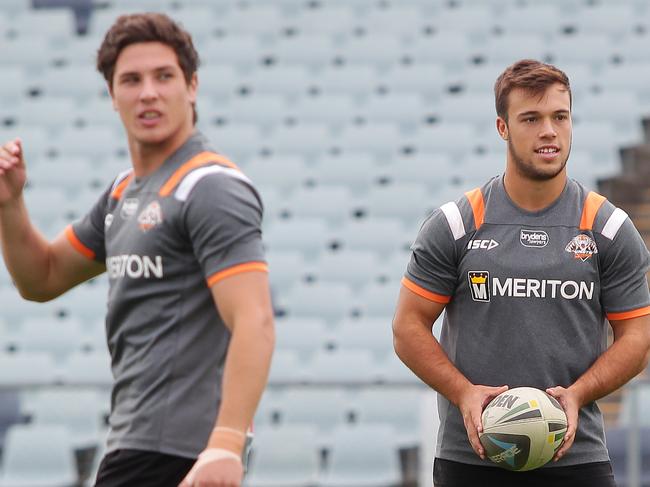 James Tedesco, wearing hat, Luke Brooks, brown/blonde hair, wearing green boots and Mitchell Moses, brown hair, white boots. Wests Tigers training ahead of there game against The Dragons.