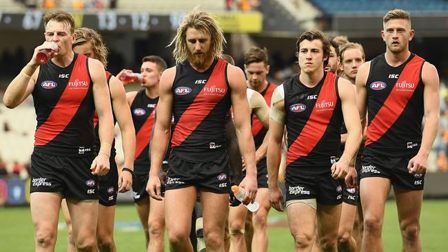 Dyson Heppell leads Essendon off after losing to Hawthorn.