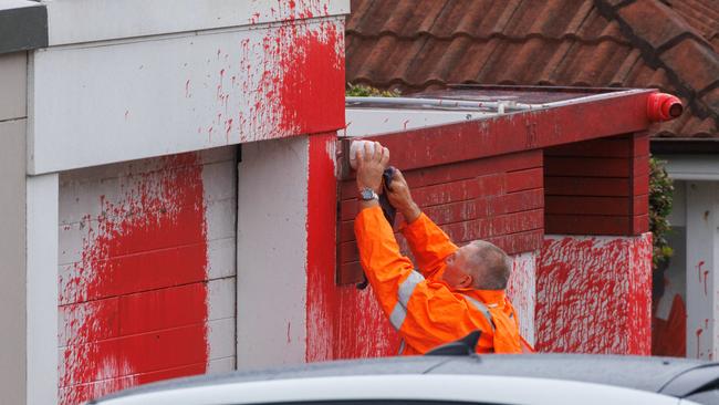 A council worker removes red paint thrown onto Jewish leader Alex Ryvchin’s former home in Dover Heights, Sydney, in January. Picture: Max Mason-Hubers