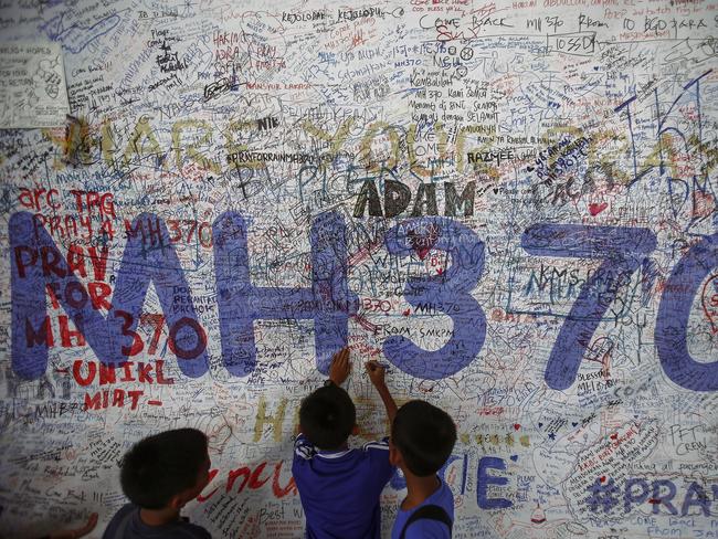 Children write messages of hope for passengers of missing Malaysia Airlines Flight MH370 at Kuala Lumpur International Airport (KLIA) outside Kuala Lumpur June 14, 2014. The only chance to solve the mystery now rests with finding the wreck, investigator say.