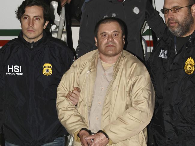 Authorities escort Joaquin ‘El Chapo’ Guzman, centre, from a plane.  Picture:  AP