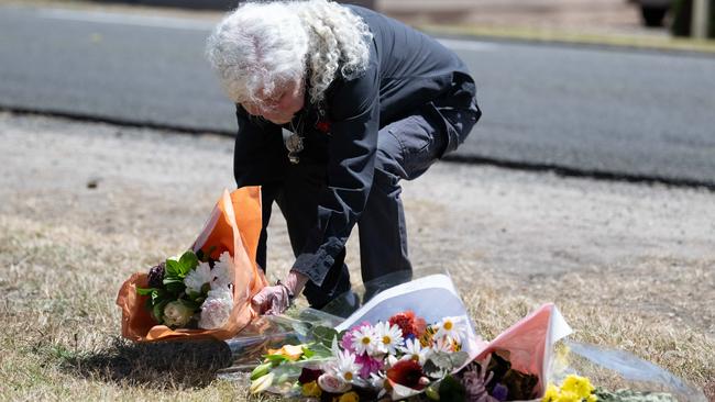 Goolwa resident Dianne Campbell leaves flowers at the crash site. Picture: The Advertiser/ Morgan Sette