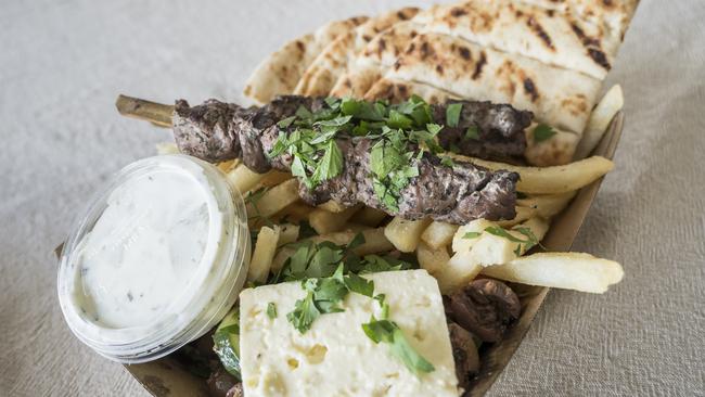 Charcoal-grilled lamb kalamaki (skewers) with pita, chips and Greek salad from Get Greek Food Truck. Picture: Caroline Tan