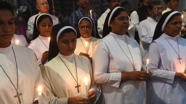 Pakistani Christians and Muslims hold candles at a tribute to Sri Lankan bomb blast victims at the Sacred Heart Cathedral Church in Lahore. Picture: AFP 