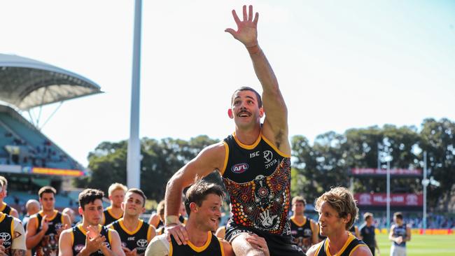 Taylor Walker gets chaired off after his 200th match by teammates Matt Crouch and Rory Sloane. (Photo by Matt Turner/AFL Photos via Getty Images)