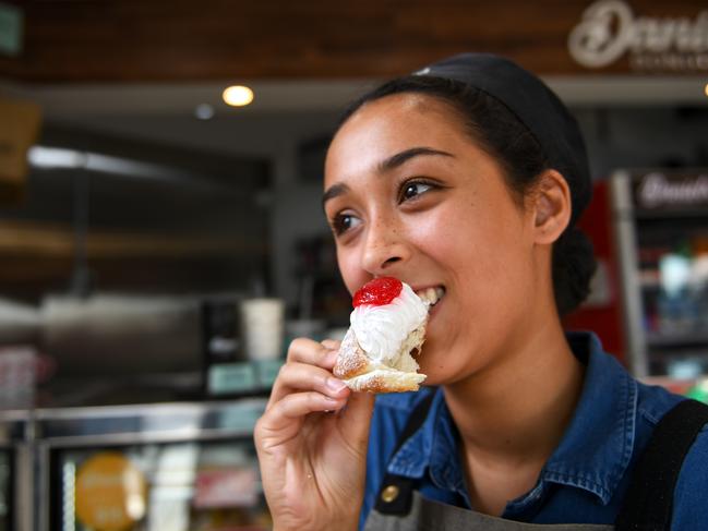 Shirani Fernando at Daniel's Donuts eating a cream and jam vegan doughnut. Picture: Penny Stephens