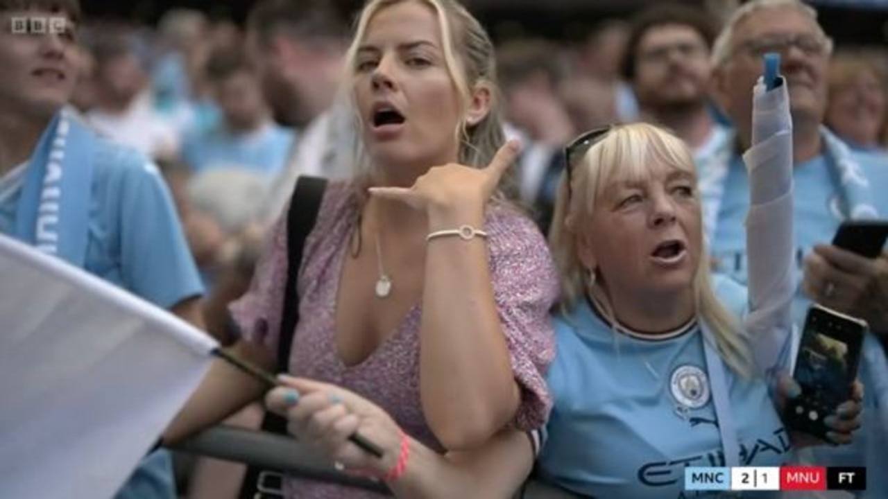 A Man City fan gestured "call me" while celebrating. Picture: BBC