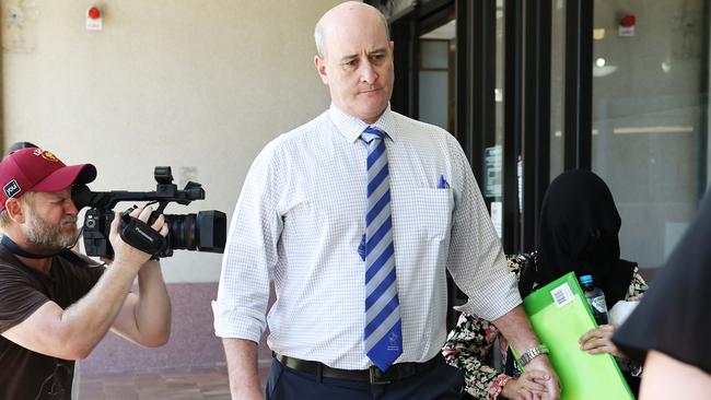 Detective Sergeant Gary Hall and Sukhdeep Kaur, the wife of Rajwinder Singh, leave the Cairns Supreme Court during a break in the trial. Brendan Radke