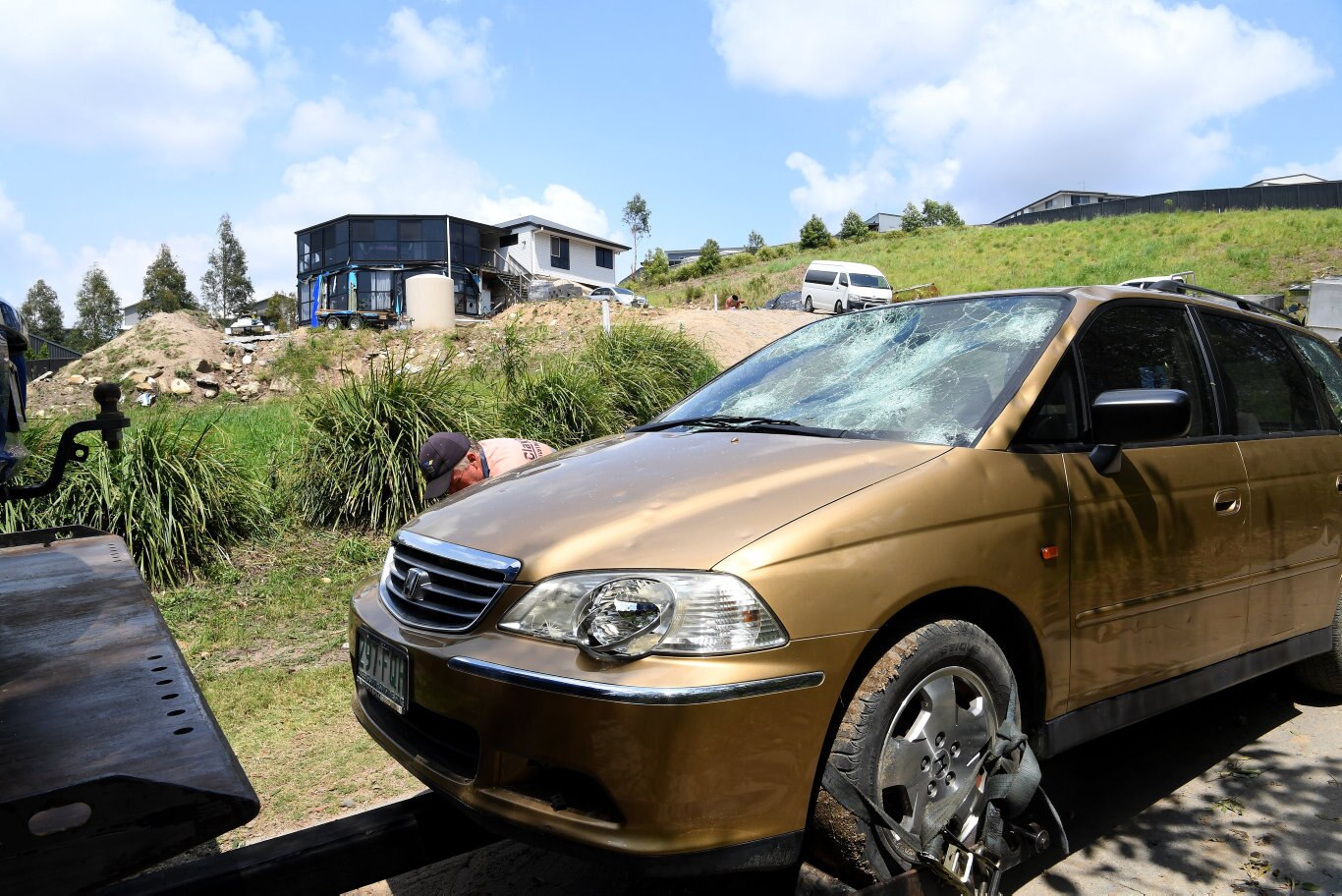 Cleaning up after the Sunday storm on the Sunshine Coast Coast. Cars are towed away in Palmview from hail damage.