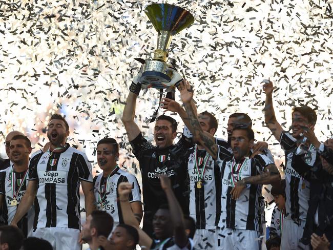Juventus' players celebrate with the trophy.