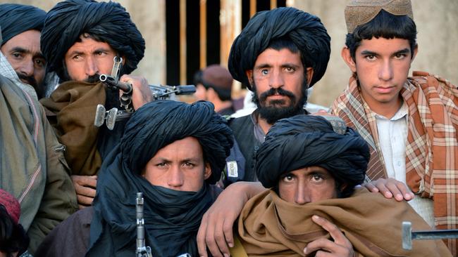 In this photograph taken on November 3, 2015, Afghan Taliban fighters look on as they listen to Mullah Mohammad Rasool Akhund (unseen), the newly appointed leader of a breakaway faction of the Taliban, at Bakwah in the western province of Farah. A breakaway faction of the Taliban has appointed its own leader in the first formal split in the Afghan militant movement under new head Mullah Mansour, posing a fresh hurdle to potential peace talks. Mullah Rasool was named the leader of the faction in a mass gathering of dissident fighters this week in the remote southwestern province of Farah, according to an AFP reporter who attended the meeting. / AFP / JAVED TANVEER