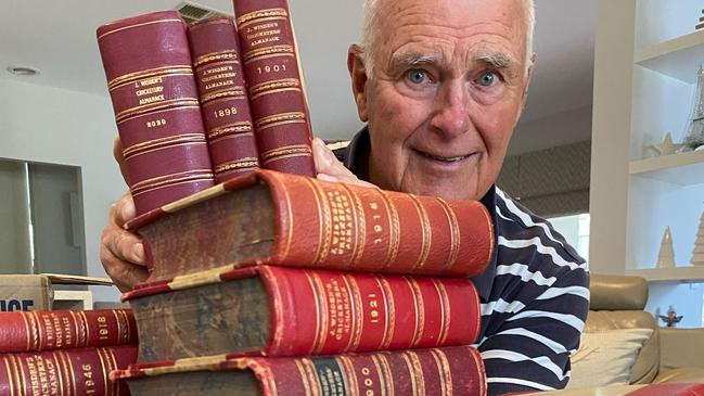 Garry Dougall with the collection of Wisden annuals.