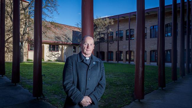 Father John Sanderson in the courtyard at Ivanhoe's St George’s Anglican Church. Picture: Mark Dadswell