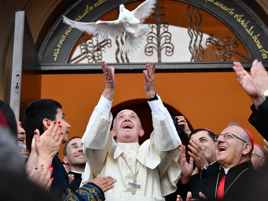 Pope Francis (C) releases a dove as a symbol of peace during a meeting with Chaldean community at the Catholic Church of St Simon Bar Sabbae in Tbilisi, on September 30, 2016. Picture: AFP