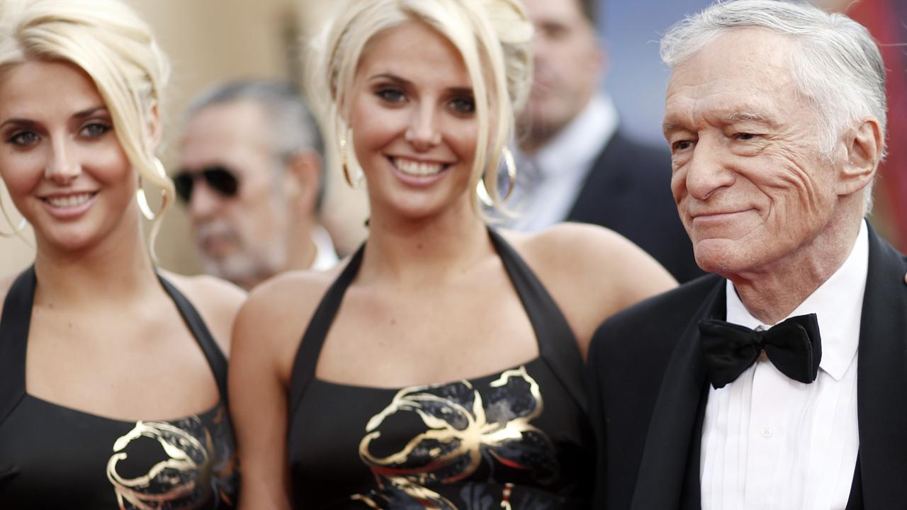 Identical twins Karissa and Kristina Shannon with Hugh Hefner in 2009. Picture: AP Photo/Matt Sayles