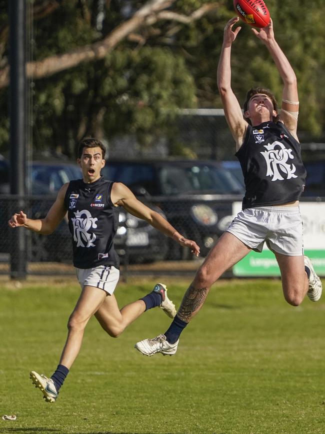 Rosebud’s Callum McNair stretches for a mark.