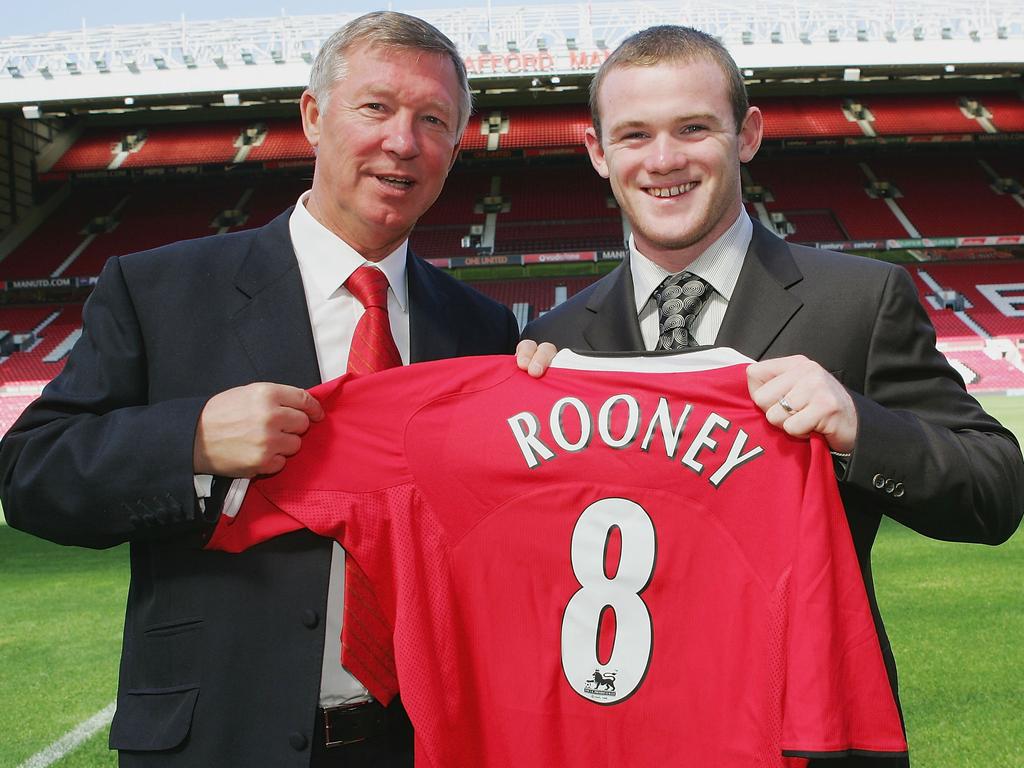 Sir Alex Ferguson poses with Wayne Rooney after he was announced as Manchester United's big new signing in September 2004. Picture: John Peters/Manchester United via Getty Images