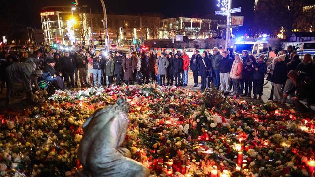 People lay flowers at a makeshift memorial near the site of the attack. Picture: AFP