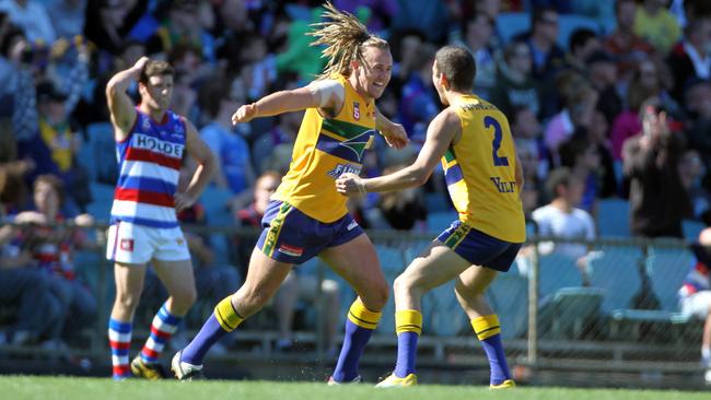 Eagle Scott Lewis celebrates a goal with teammate Jimmy Toumpas in the 2011 grand final.