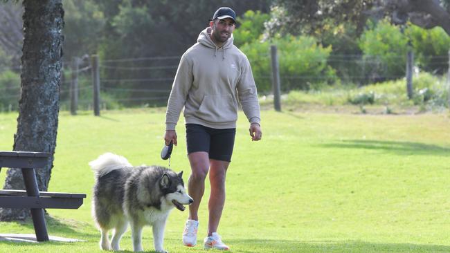 Paul Vaughan walks his dog at Shellharbour Beach on Tuesday. Picture: Simon Bullard