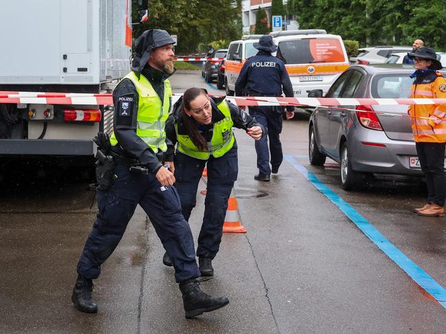 Police officers are seen outside of a daycare centre where a man attacked several children injuring three, before being arrested, in Zurich, Switzerland, on October 1, 2024. A stabbing attack on children outside a Zurich daycare centre left one boy seriously wounded and two others injured, said police who detained a Chinese national. The three children hurt in the attack were treated by paramedics and taken to hospital. (Photo by ARND WIEGMANN / AFP)