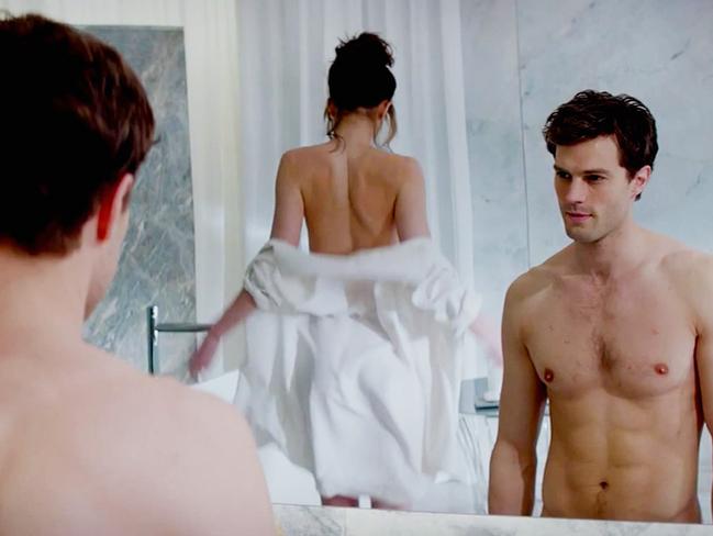 Jamie Dornan with Dakota Johnson in a scene from fifty Shades of Grey.