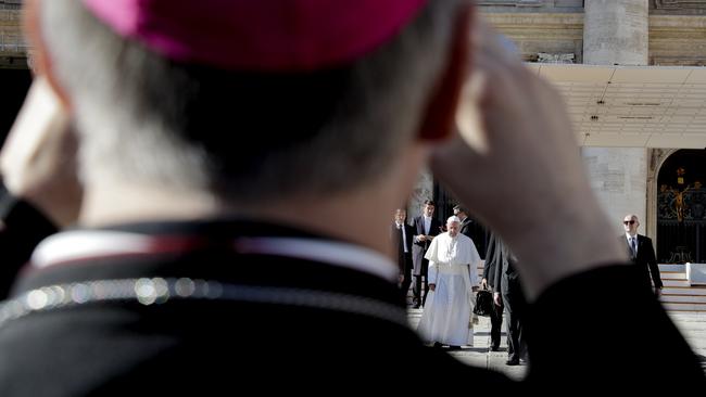 A bishop takes photos of Pope Francis. Picture: Andrew Medichini/AP