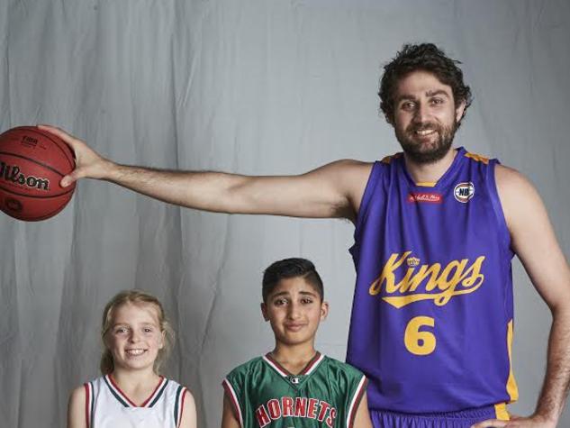 Sydney Kings star Julian Khazzouh with Hills Hornets' Charlotte Wilson and Arvin Khosravi Nia.