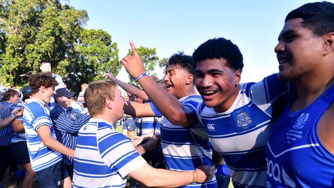 Nudgee’s Rob Toia, facing camera, and supporters celebrate the win. Picture, John Gass