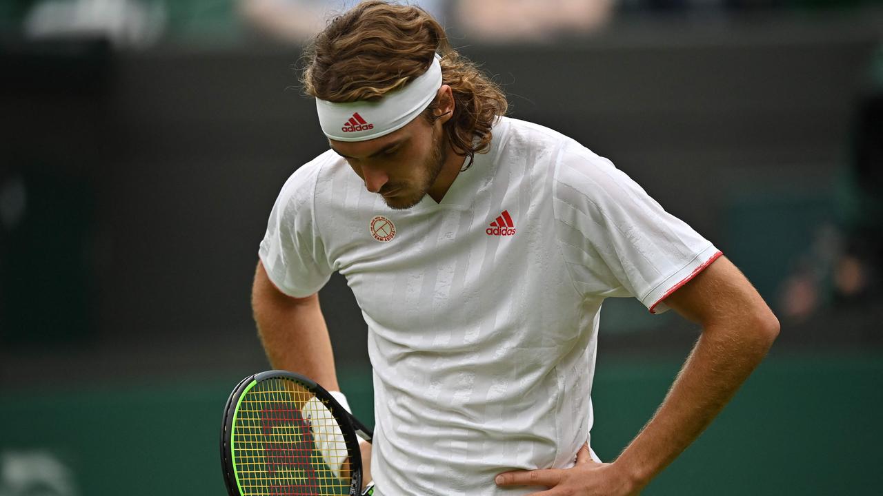 Greece's Stefanos Tsitsipas reacts to a missed shot against US player Frances Tiafoe during their men's singles first round match on the first day of the 2021 Wimbledon Championships at The All England Tennis Club in Wimbledon, southwest London, on June 28, 2021. (Photo by Ben STANSALL / AFP) / RESTRICTED TO EDITORIAL USE