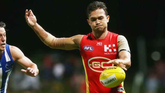 Action from the AFL match between the Gold Coast Suns and the North Melbourne Kangaroos, held at Cazalys Stadium, Cairns. Gold Coast's Jarrod Harbrow kicks down field. PICTURE: BRENDAN RADKE