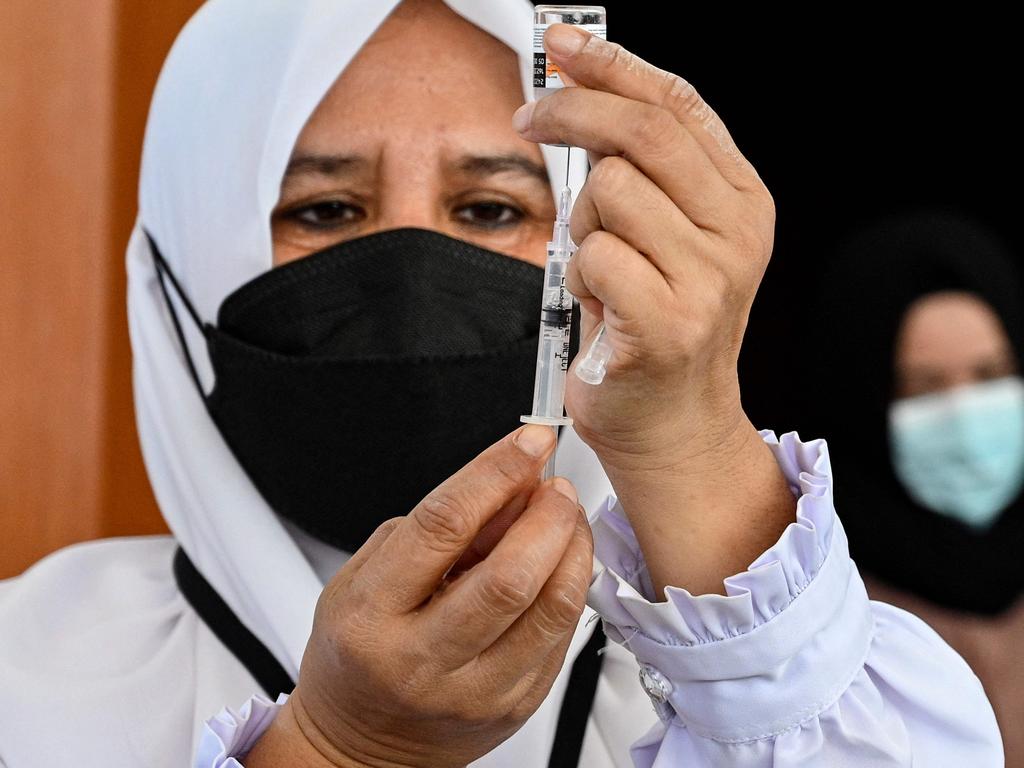 A health worker prepares a dose of the Sinovac vaccine. The vaccine has just been approved in the country to administer to those aged 12-17. Picture: Chaideer Mahyuddin/AFP