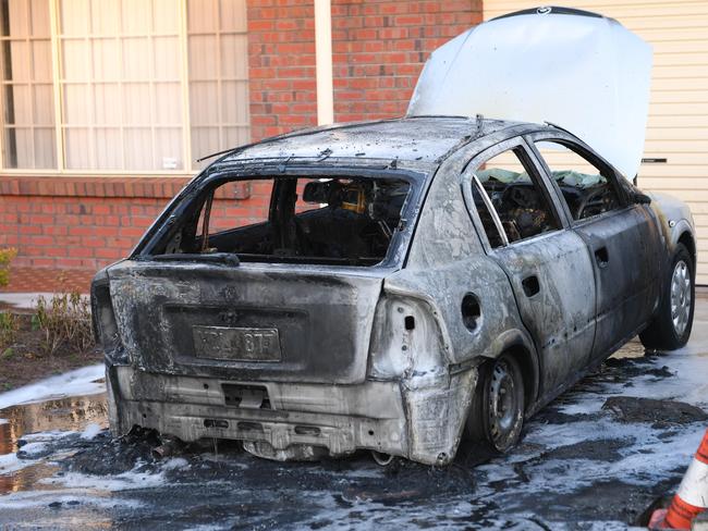 A car was destroyed in a deliberate fire in the driveway of a home at Lockleys on Tuesday, an incident police have linked to the ongoing bikie feud. Picture: AAP / Mark Brake