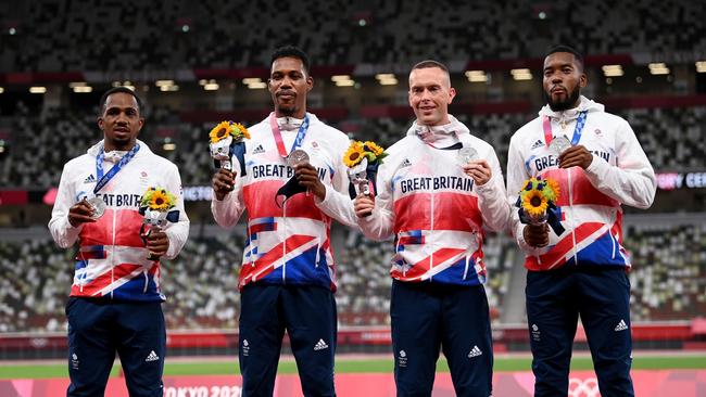 TOKYO, JAPAN - AUGUST 07:  Silver medal winners CJ Ujah, Zharnel Hughes, Richard Kilty and Nethaneel Mitchell-Blake of Team Great Britain stand on the podium during the medal ceremony for the Men's 4 x 100m Relay on day fifteen of the Tokyo 2020 Olympic Games at Olympic Stadium on August 07, 2021 in Tokyo, Japan. (Photo by Matthias Hangst/Getty Images)
