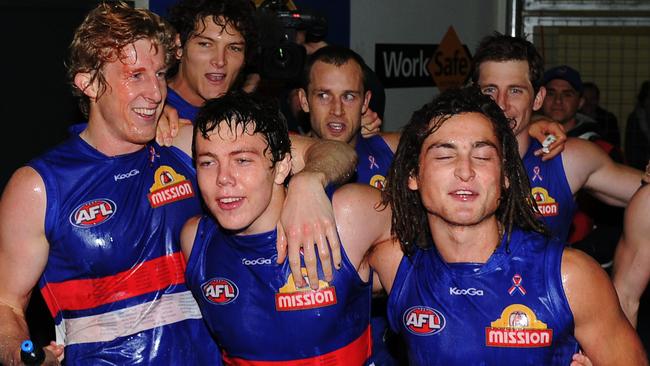 Luke Dahlhaus (right) celebrates his first AFL win with Jayden Schofield and Ed Barlow.